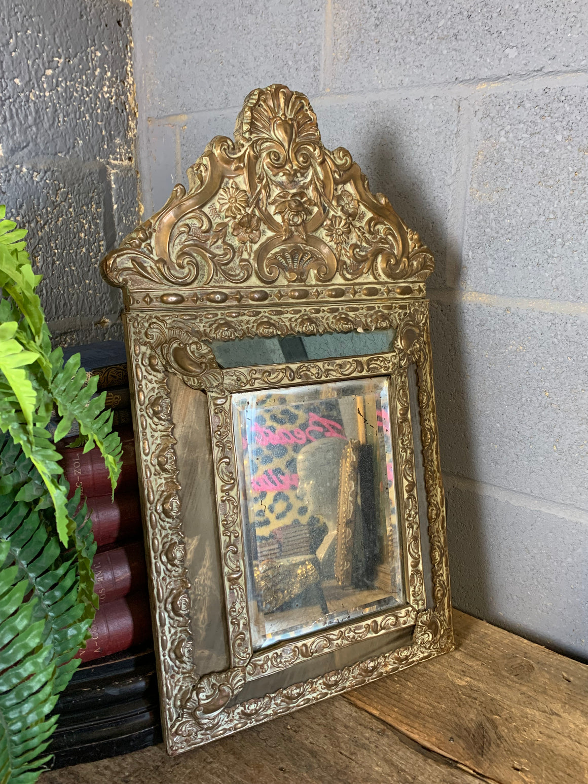 A large brass repousse mirror