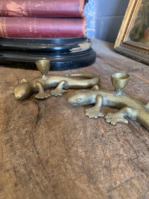 A pair of brass candlesticks in the form of lizards