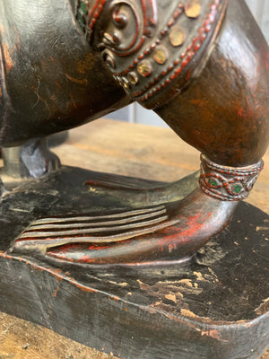 A carved wooden Manussiha sphinx statue