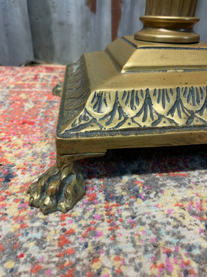 A brass Corinthian column standard lamp on lion paw feet