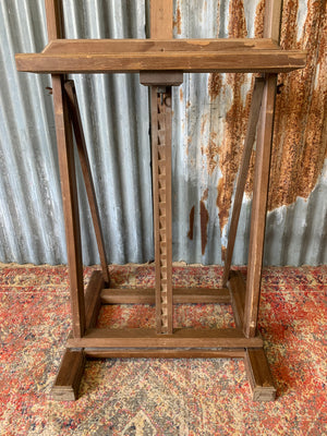 A floor standing and foldable wooden artist's easel