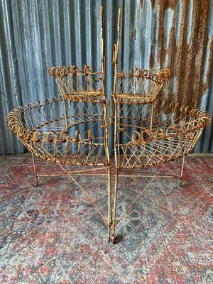 A pair of white wirework demi-lune plant stands