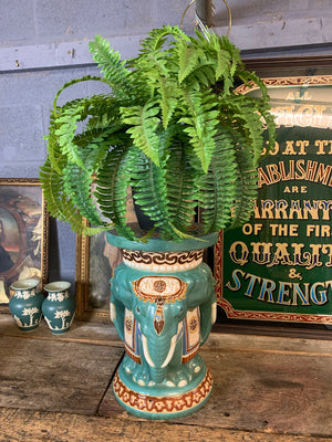 A large ceramic elephant head jardiniere