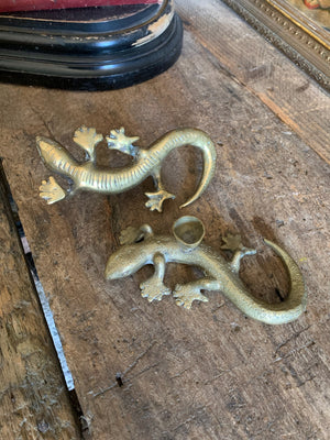 A pair of brass candlesticks in the form of lizards