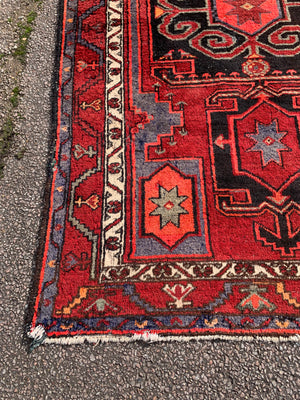 A Turkish red ground rug ~ 211cm x 138cm