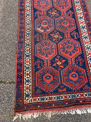 A long red ground blue Persian runner rug ~ 304cm x 104cm