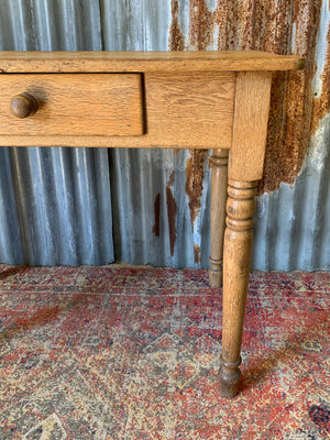 A Victorian oak table with single drawer