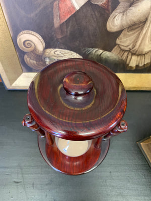 A mahogany rotating hourglass or sand timer