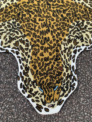 A Liberty of London faux leopard skin rug