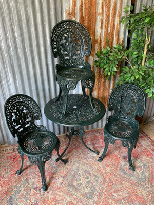 A green garden table and chairs set