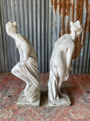 A pair of cast stone Pandora statues