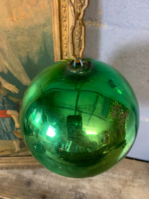 A large green mercury glass witches ball