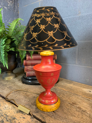 A pair of red and black toleware lamps