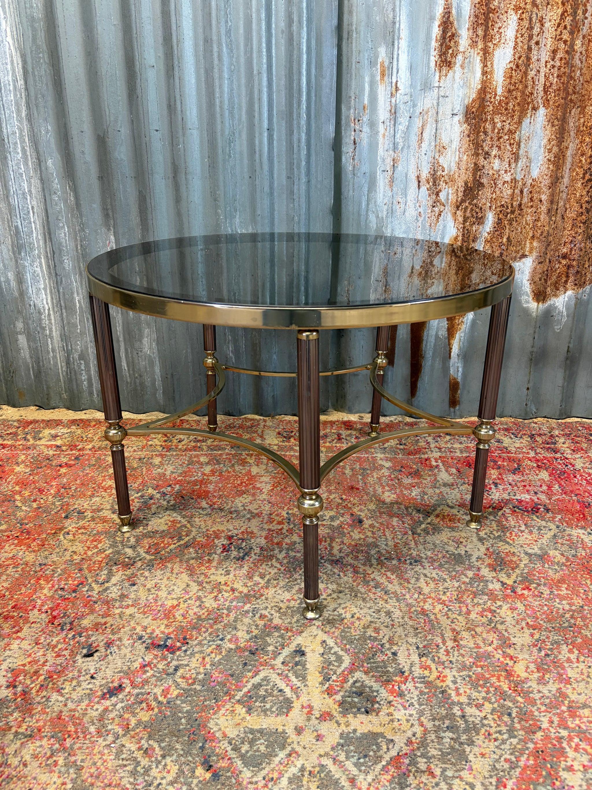 A rare circular brass and glass Hollywood Regency coffee table