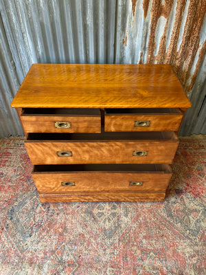 A satinwood chest of drawers