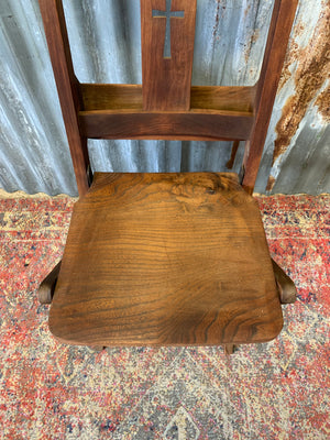 An Edwardian oak folding chapel chair by Mealing Bros