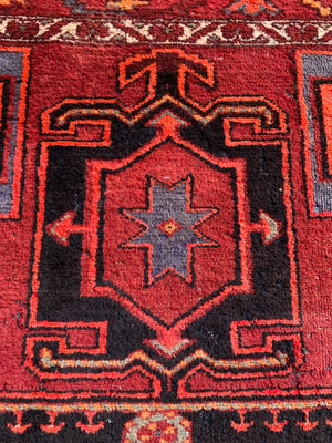 A Turkish red ground rug ~ 211cm x 138cm