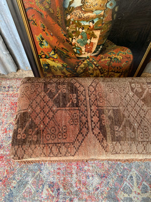 A large Persian carpet footstool