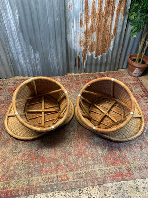 A pair of wicker egg chairs