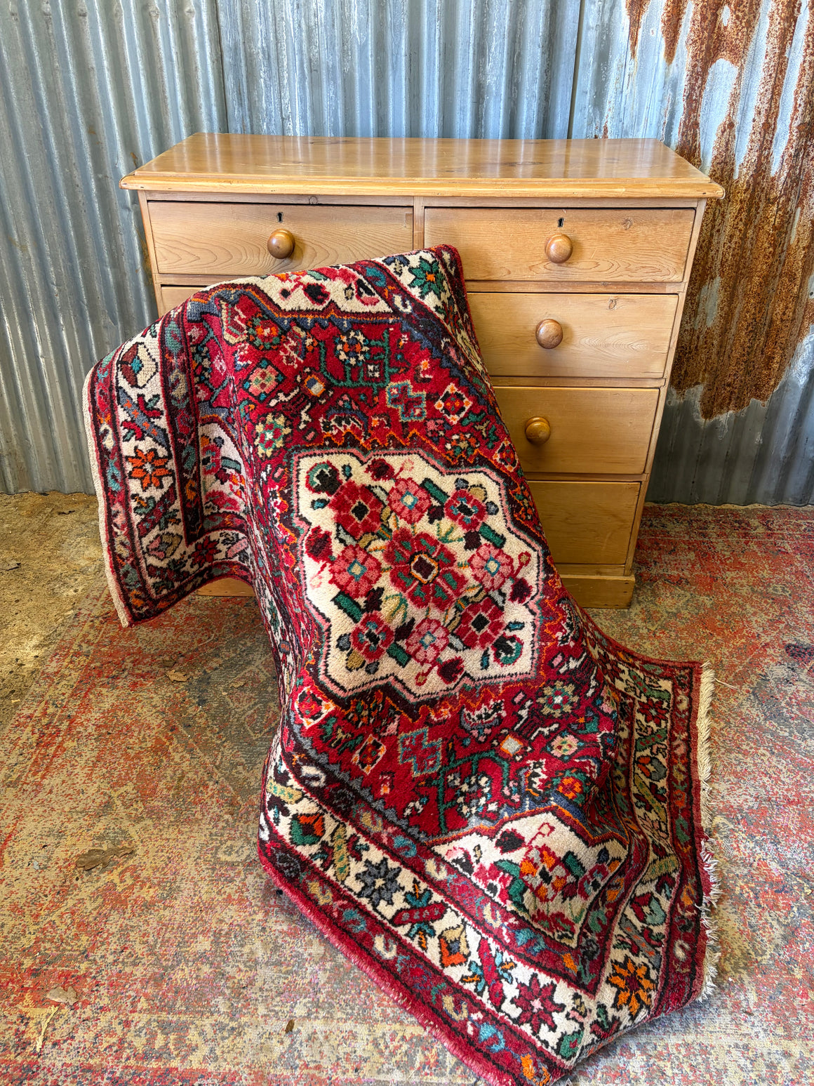 A red ground floral patterned rug ~ 158cm x 106cm