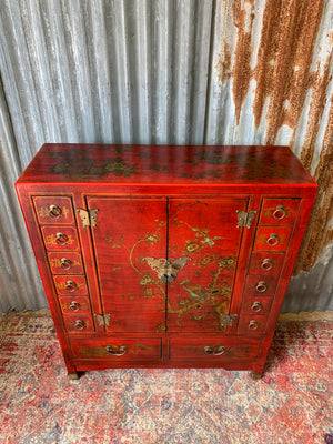 A red and gold lacquered chinoiserie cabinet