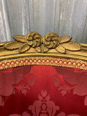 A pair of red damask giltwood open armchairs