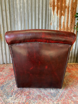 An oxblood red leather club chair