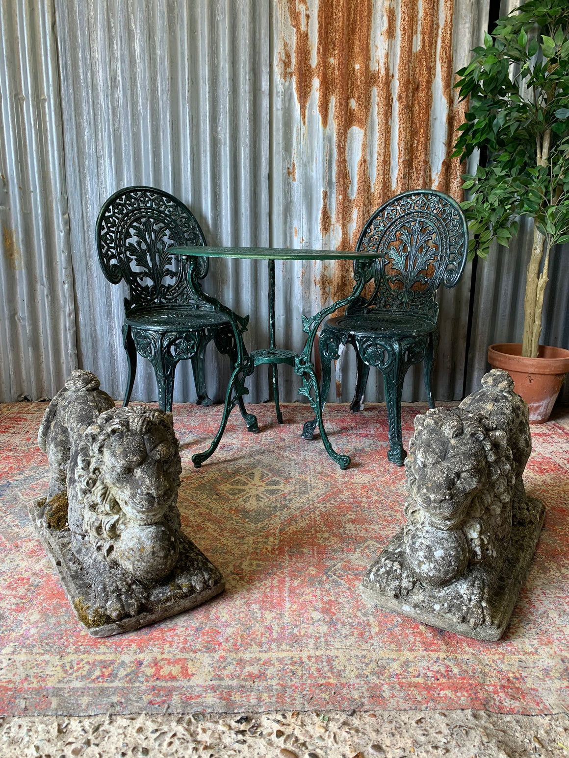 A green garden table and chairs set