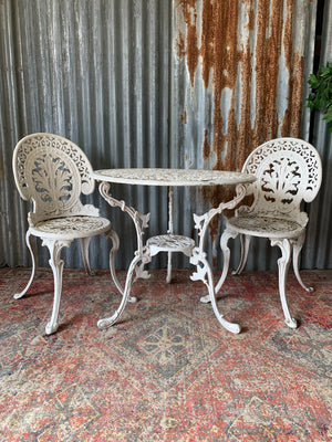 A white garden table and two chairs set