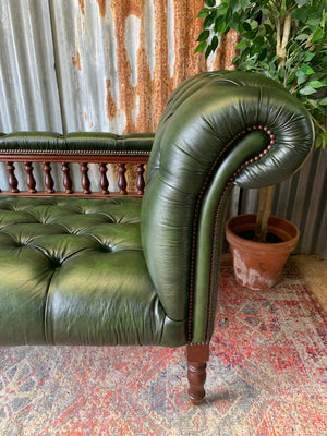 A Victorian-style green leather chaise longue