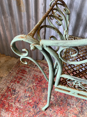 An ornate cast metal garden bench