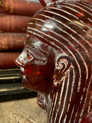 A carved bust of Tutankhamen in red Faturan