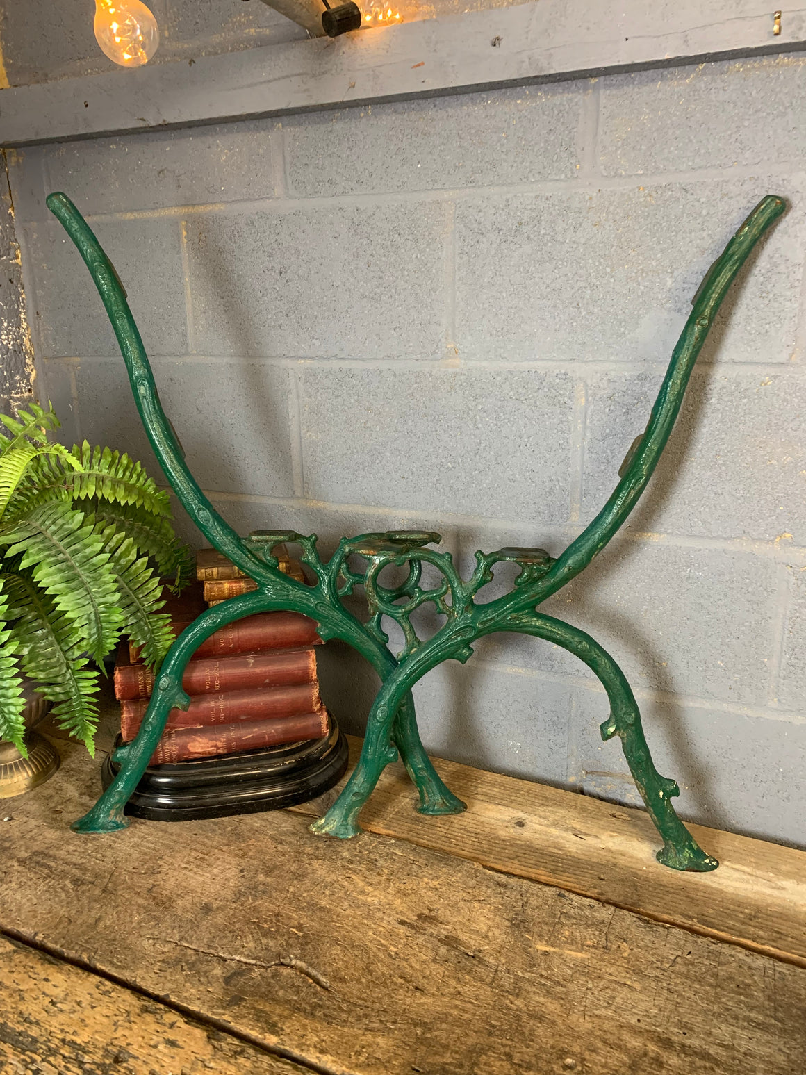 A pair of green cast iron twig bench ends