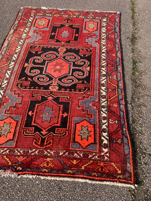 A Turkish red ground rug ~ 211cm x 138cm