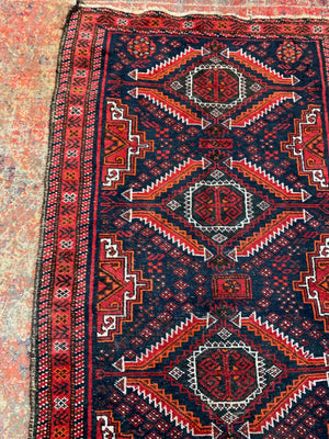 A Persian red & blue ground rectangular rug ~ 179cm x 96cm