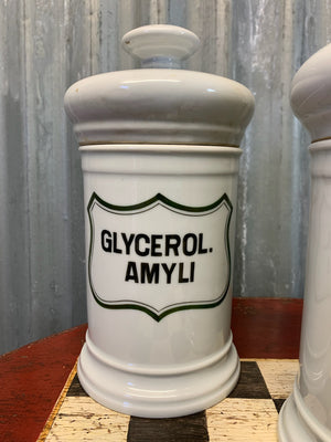 A set of three white ceramic apothecary jars