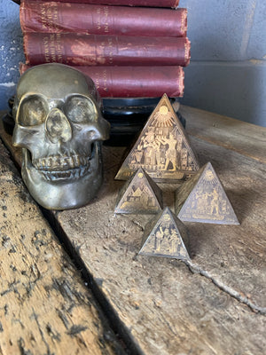 A group of four etched brass Egyptian revival pyramids