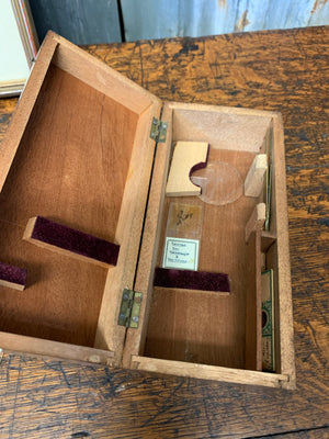 A cased Deyrolle student microscope with slides