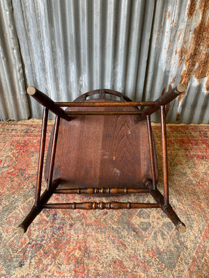 An oak spindle back captain's chair