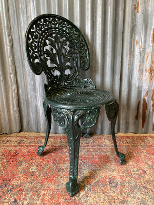 A green garden table and chairs set