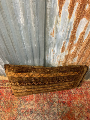 A large golden Persian carpet cushion