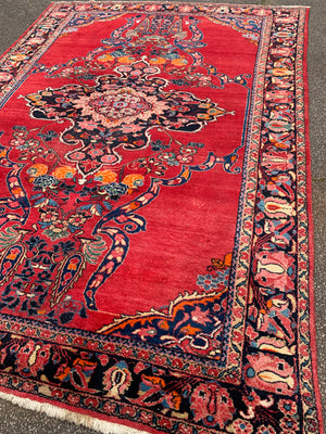 A very large rectangular red ground Persian floral rug ~ 12ft x 8ft