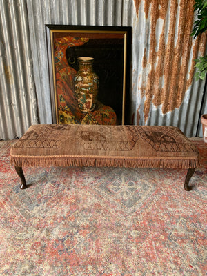 A large Persian carpet footstool