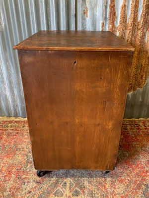 A pine chest of six drawers on castors