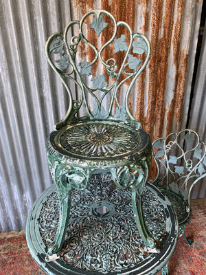 A green garden table and two chair bistro set