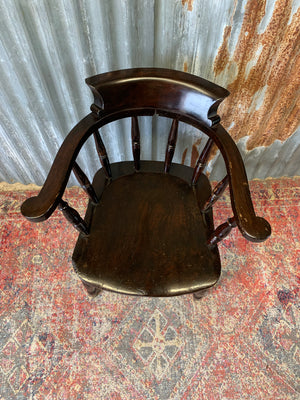 A dark wood captain's chair