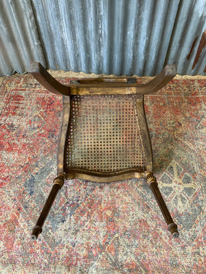 A rococo-style giltwood cane chair