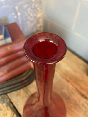 A large red glass carboy