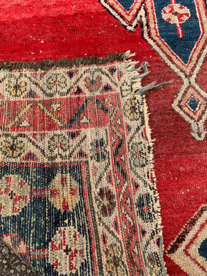 A rectangular red ground Persian rug ~ 190cm x 128cm