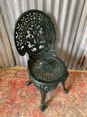 A green garden table and chairs set